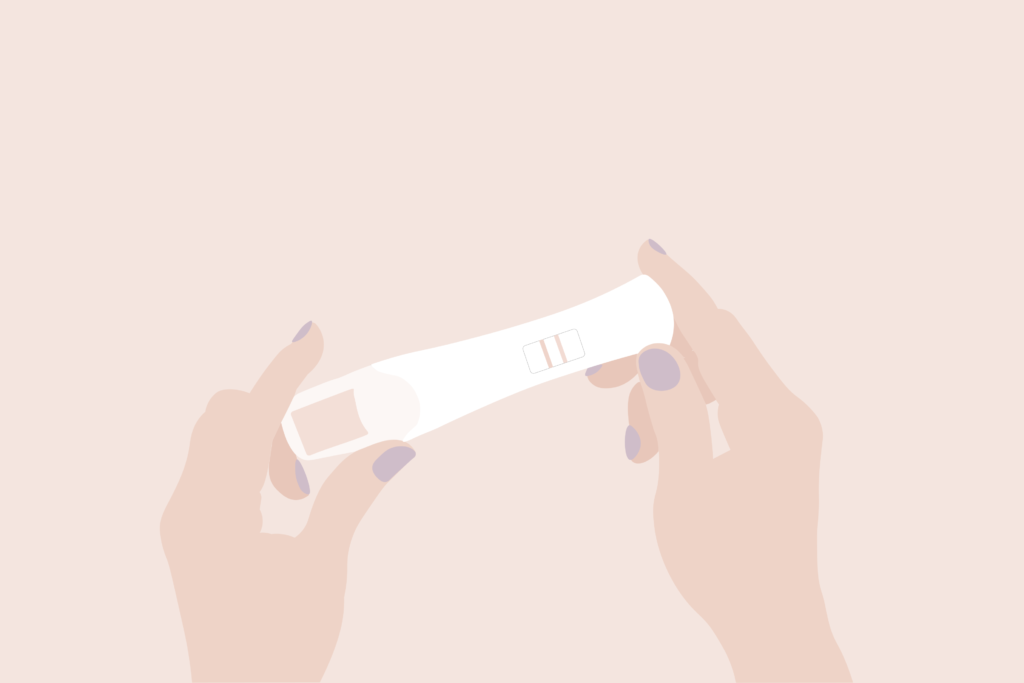 manos sujetando test embarazo